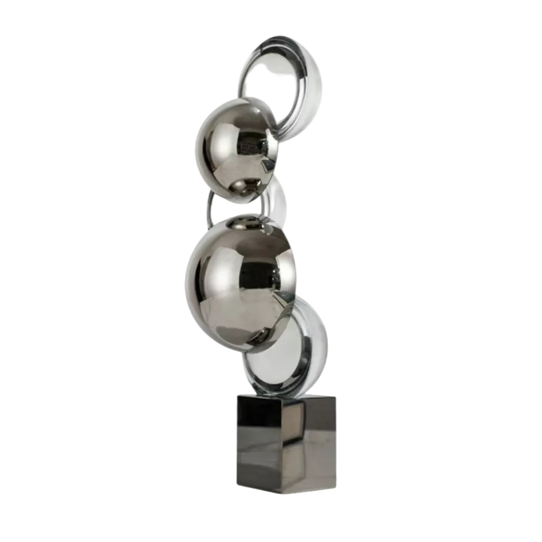 Decorative sculpture with stacked metallic spheres on a white background
